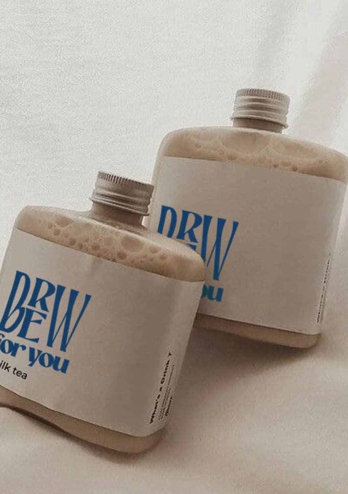 Two bottles of milk tea with Brew for You labels, close up