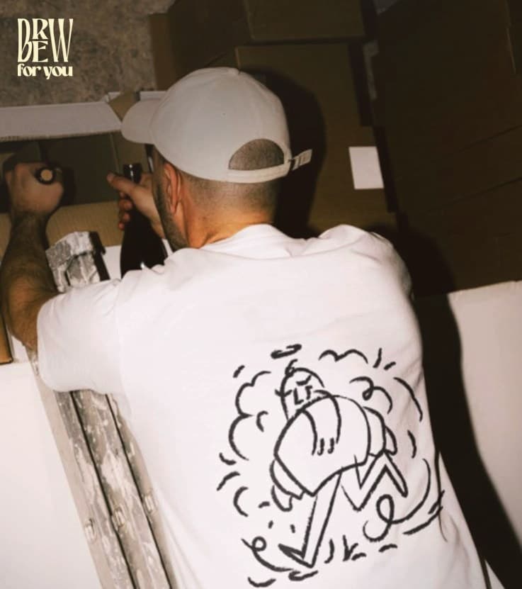 The back of a staff T-shirt with an illustrated character