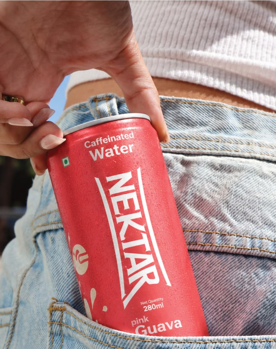 A can of Nektar pink guava tucked into the back pocket of a pair of jeans