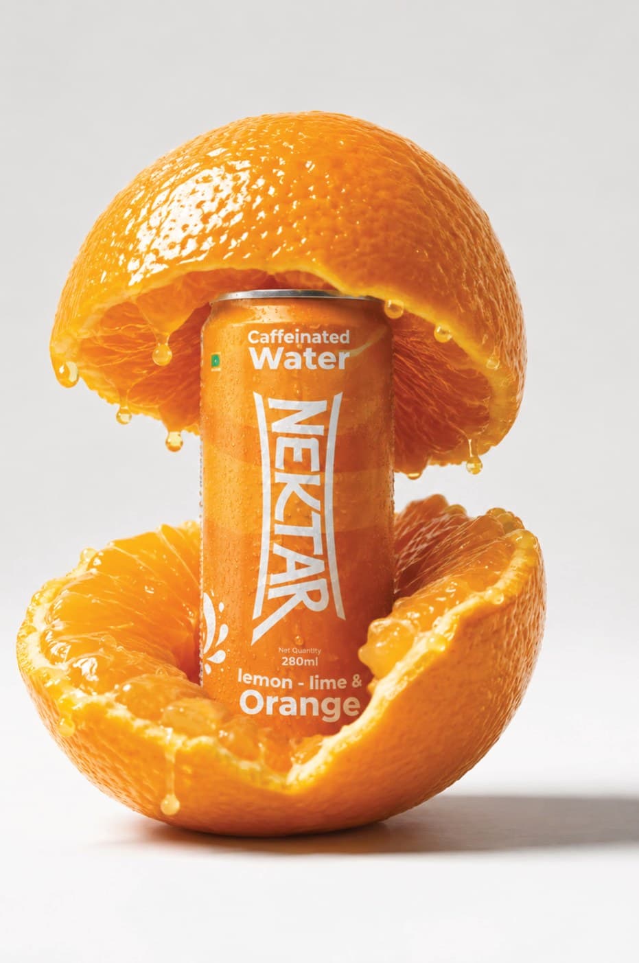 A can of Nektar lemon-lime & orange nestled inside a split orange