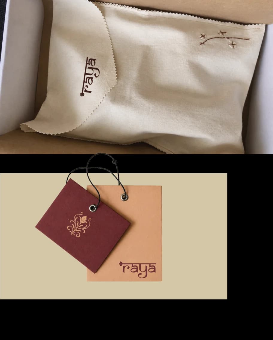 A cream dust bag stitched with the Raya logo, and a maroon swing tag on a blush card