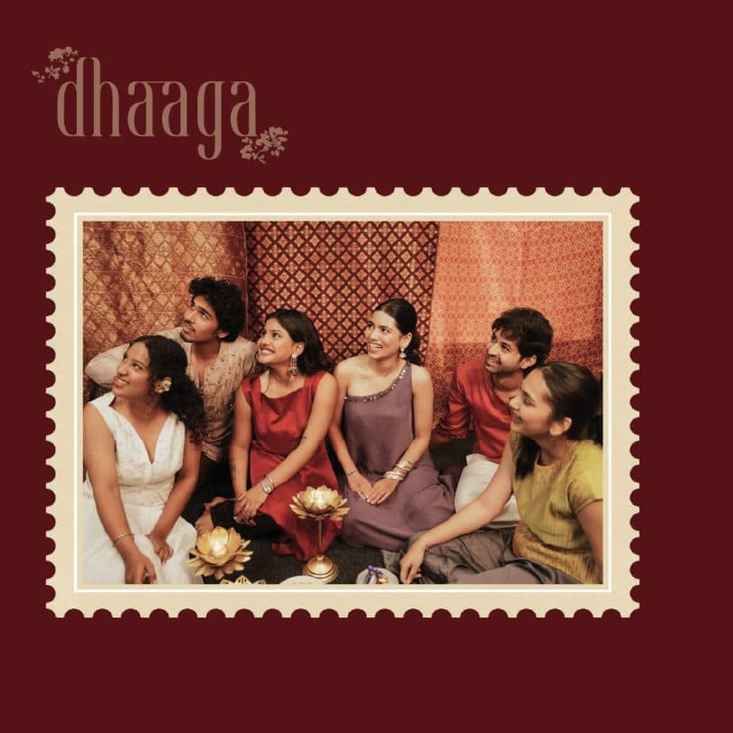 A maroon card framing a group photo as a postage stamp under the Dhaaga wordmark