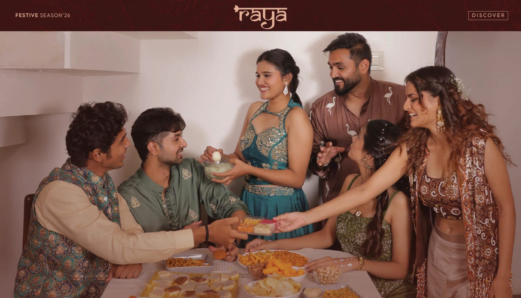 The Raya website’s festive-season banner: friends in festive wear sharing sweets