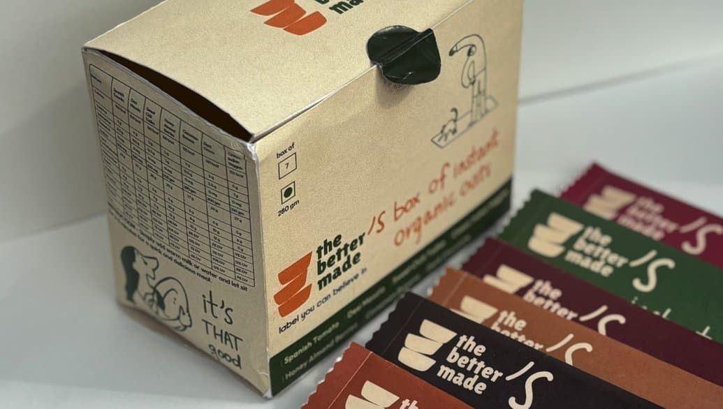The box of instant organic oats beside a spread of sachets